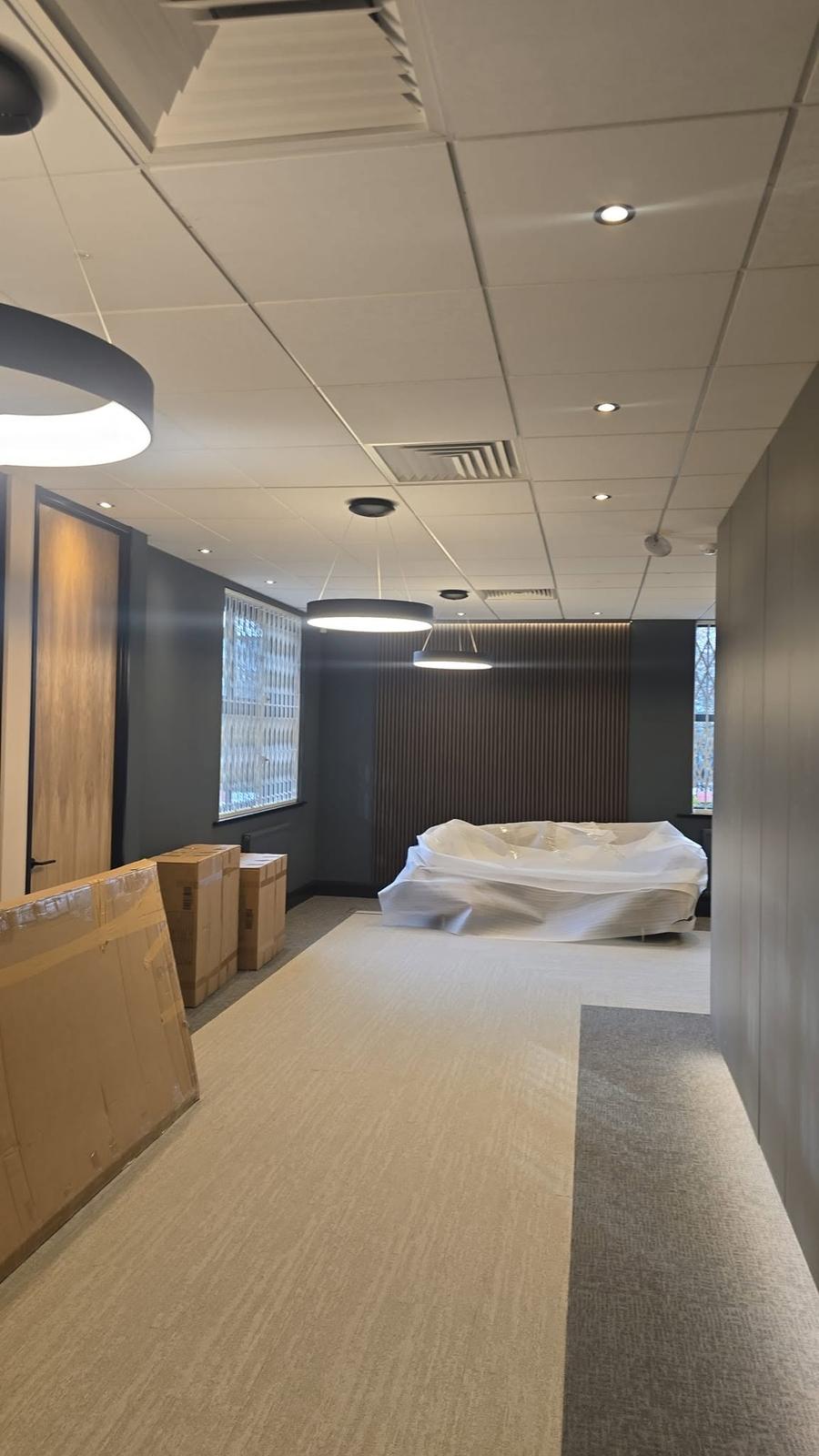 Reception and breakout area fit-out with feature wood panelling and pendant lighting